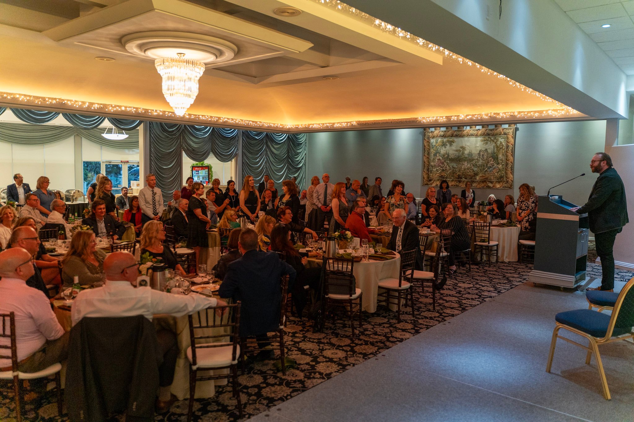 Father Roger blessing retirement gala crowd