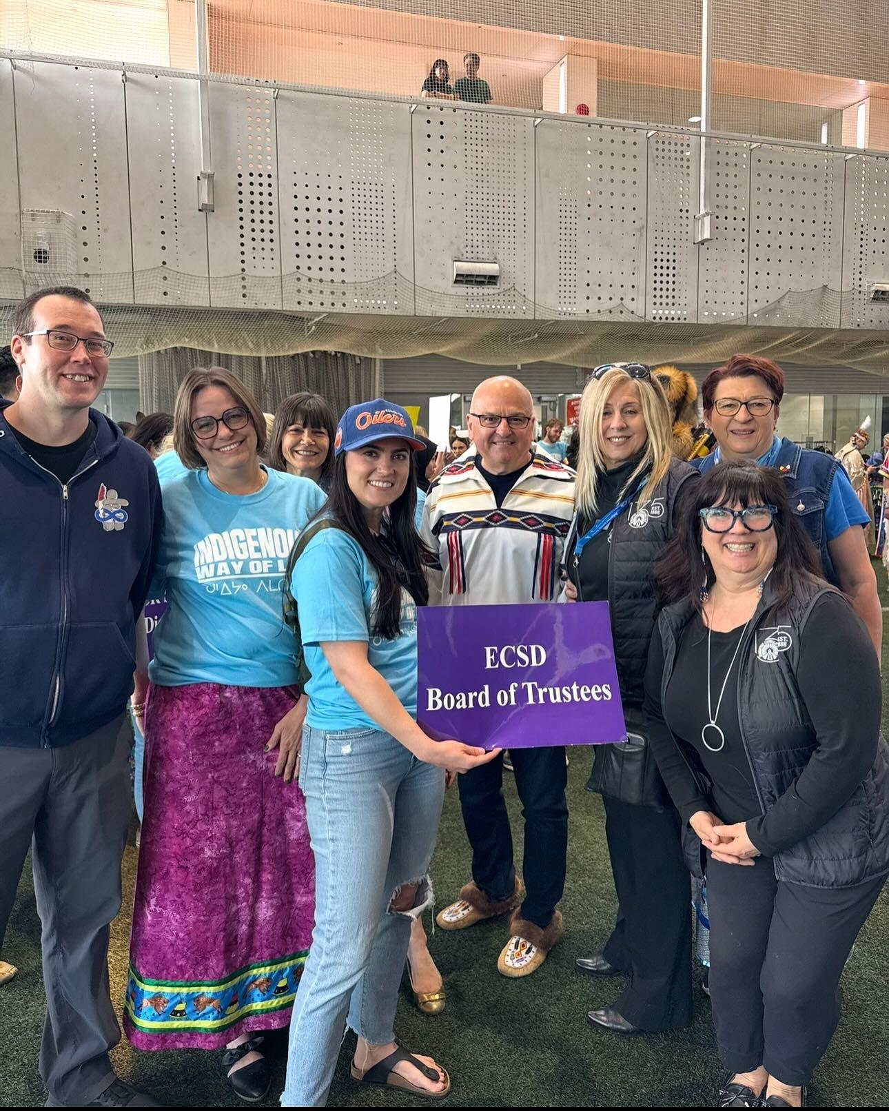 Board of Trustees posing for a photo with a sign that says ECSD Board of Trustees