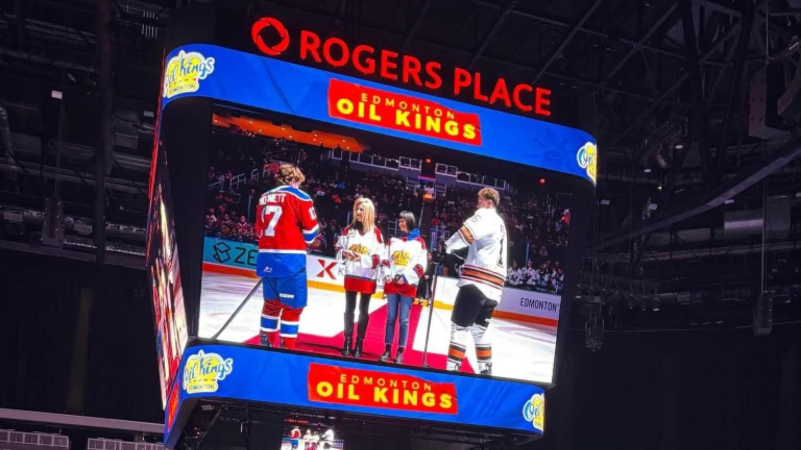 Score clock screen with Chair Palazzo and Chief Superintendent dropping the puck